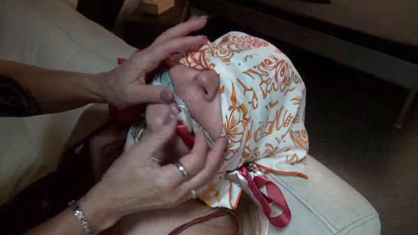 2 ladies are playing around with silk scarves